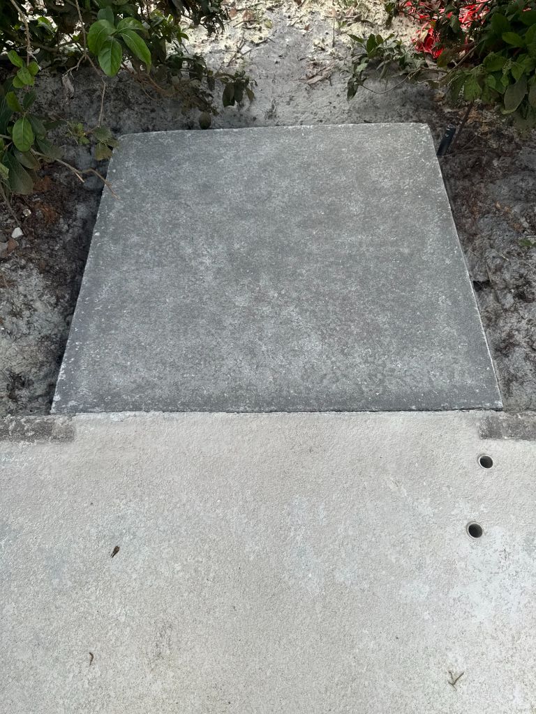 Close-up of sandblasted pool deck access panel — clean, uniform concrete surface with perfect texture for recoating