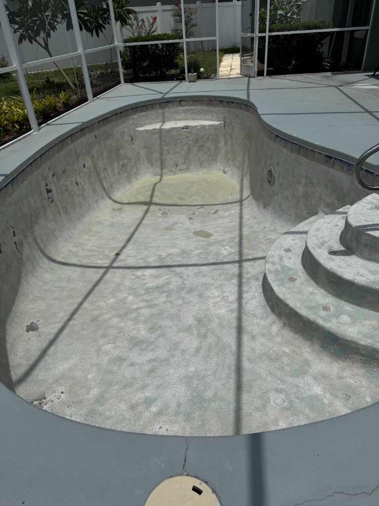 Pool shell after blasting — all paint removed, raw surface fully exposed and ready for resurfacing